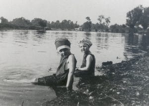 100.1997/13. Winifred and Eileen Newman in their swimming costumes, bathing in the River Thames at Weybridge.