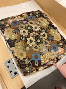 A quilted Victorian cushion cover. 