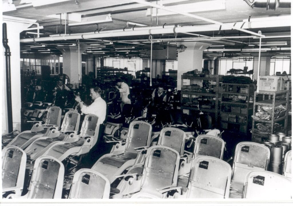 The interior of the Amalgamated Dental Factory Works, Walton, c.1967, showing two men working in part of the Dental Chair Assembly Department.