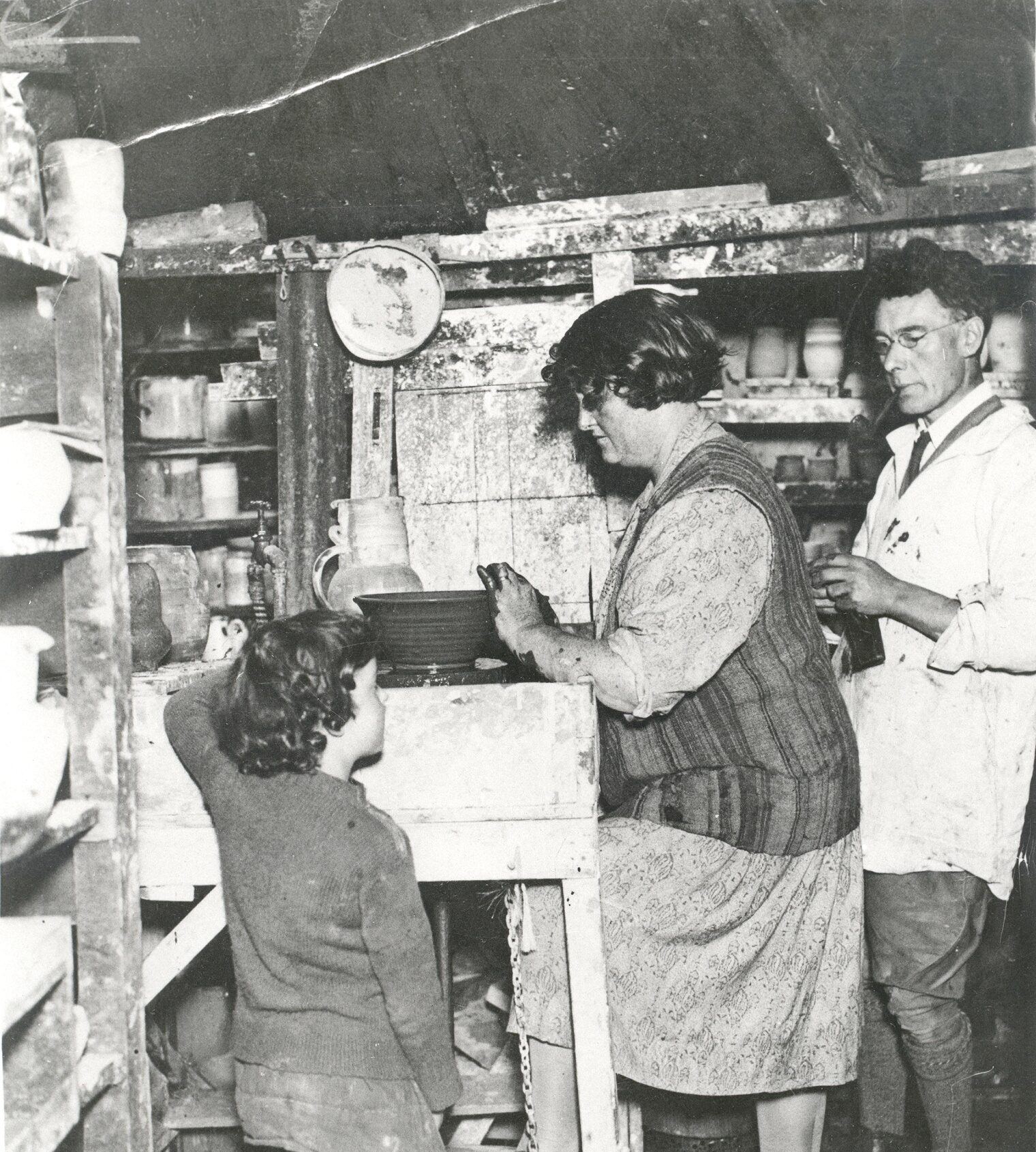Rosemary Wren (aged 7), Denise and Henry Wren in the studio at ''Potters Croft''. Denise is working at a pot on the wheel, with Rosemary and Henry looking on.