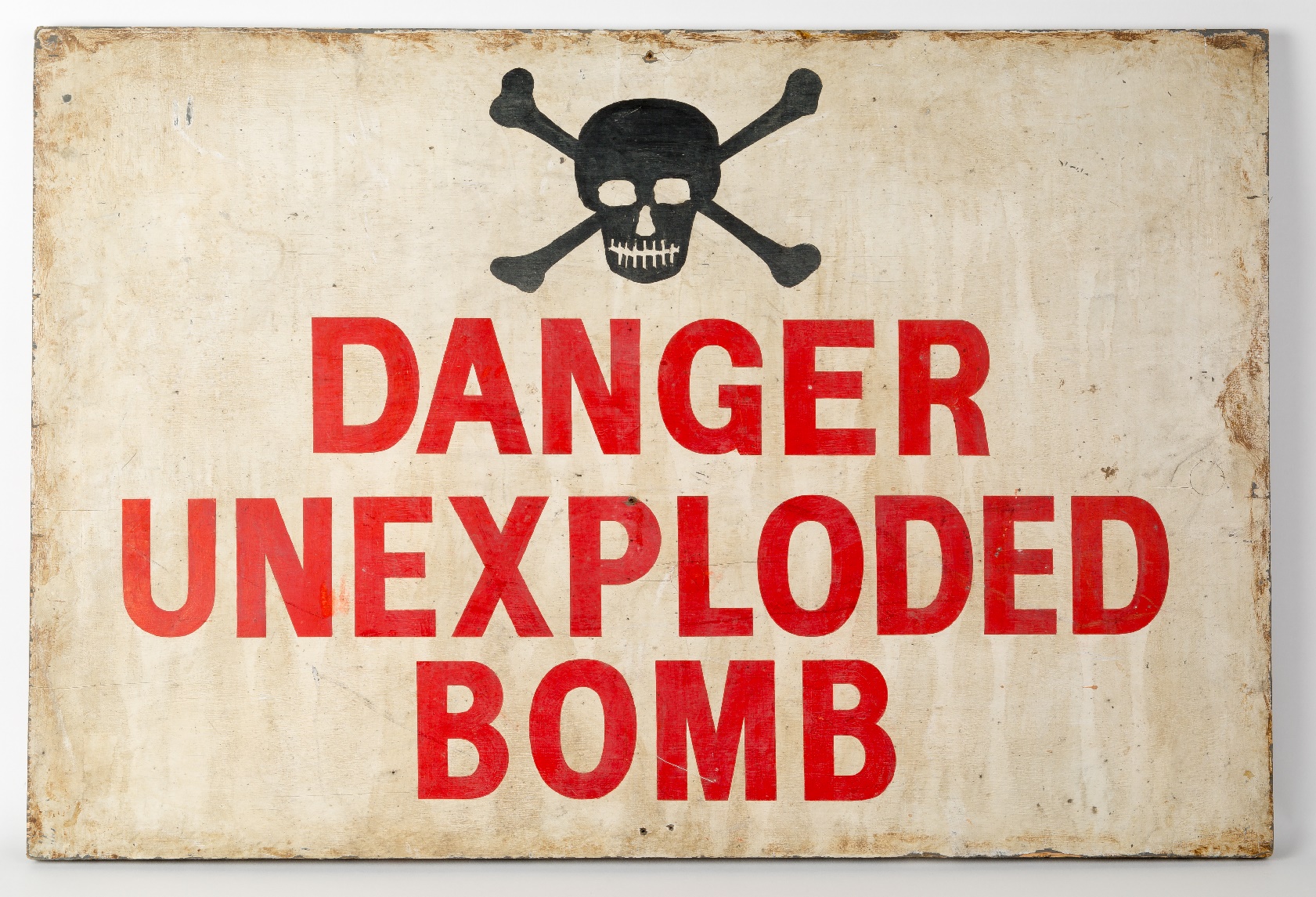 A sign displaying the warning 'Danger unexploded bomb'