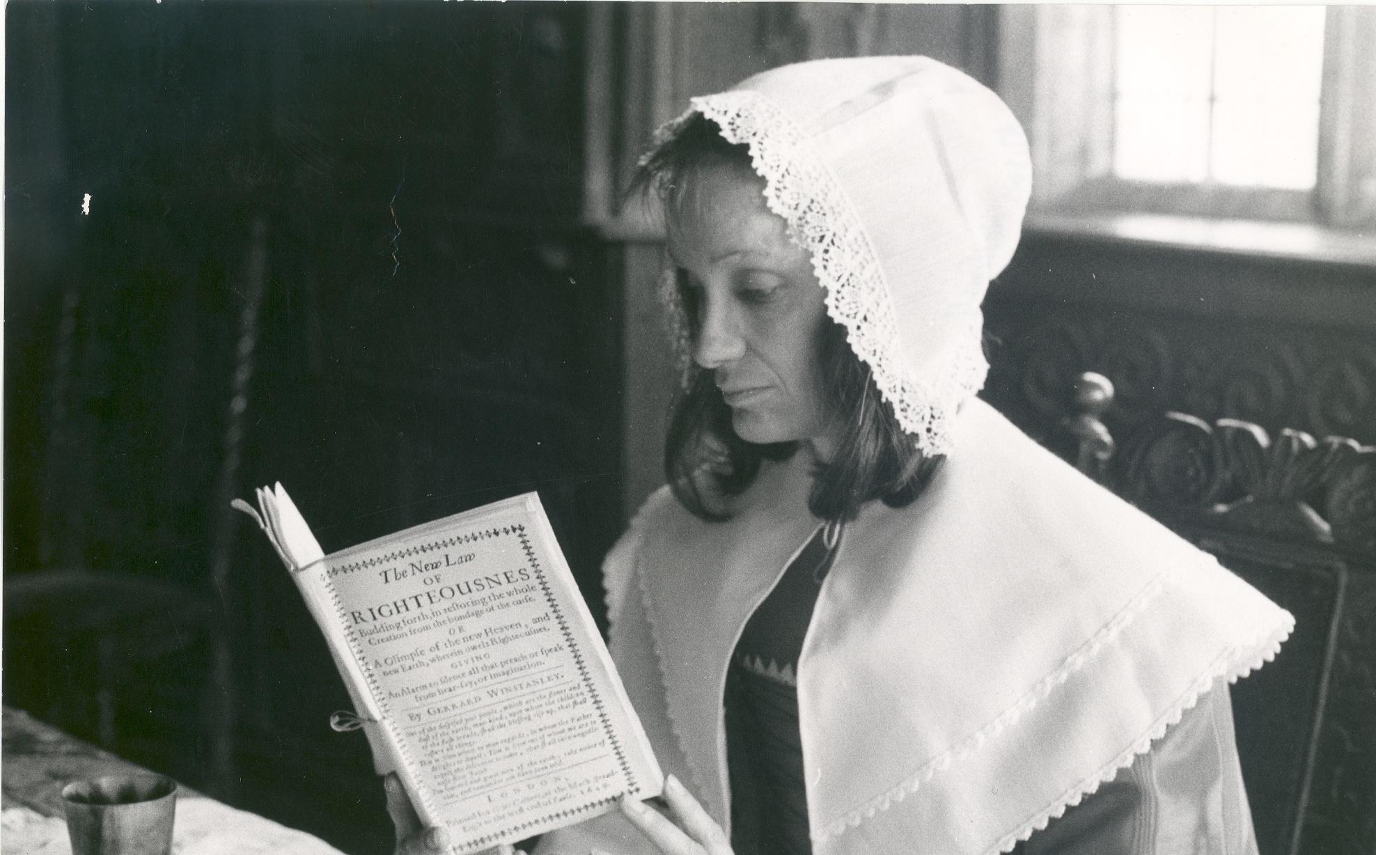 Woman reading one of Winstanley's pamphlets in the 1975 film 'Winstanley'