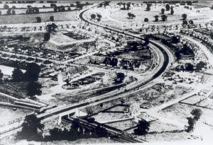 Aerial view of Hinchley Wood, showing the railway station and construction of housing estates around the Kingston by-pass, c.1934.