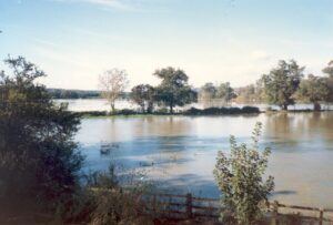 View from Downside Bridge, Cobham, the morning after the great storm on 16th October 1987 - looking south-west and showing the flooded fields. 
