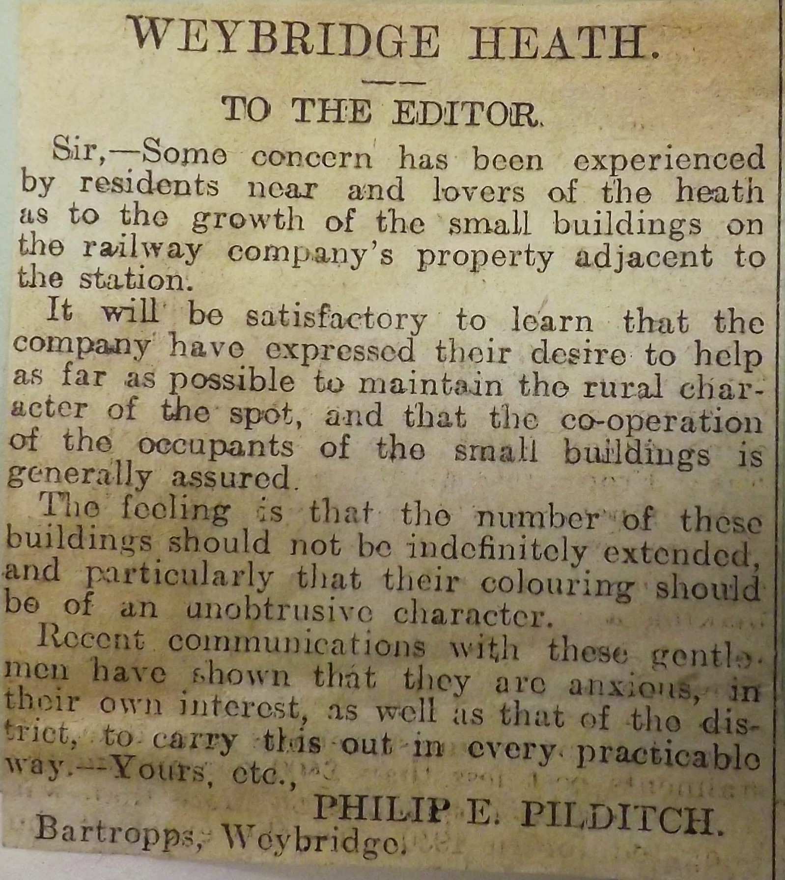 Article from a scrapbook compiled by Sir Philip Pilditch of articles, letters and news cuttings relating to Weybridge Heath, The Commons Preservation Society and the Weybridge Poors Allotments. The article raises concerns about building over and developing common land. It is dated May 1930.