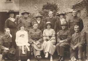 A sepia photograph of a group at a wedding at Mount Felix Military Hospital, c.1915-16. The wedding group are mainly New Zealanders, and the donor's wife sits in the front row with a baby on her lap.