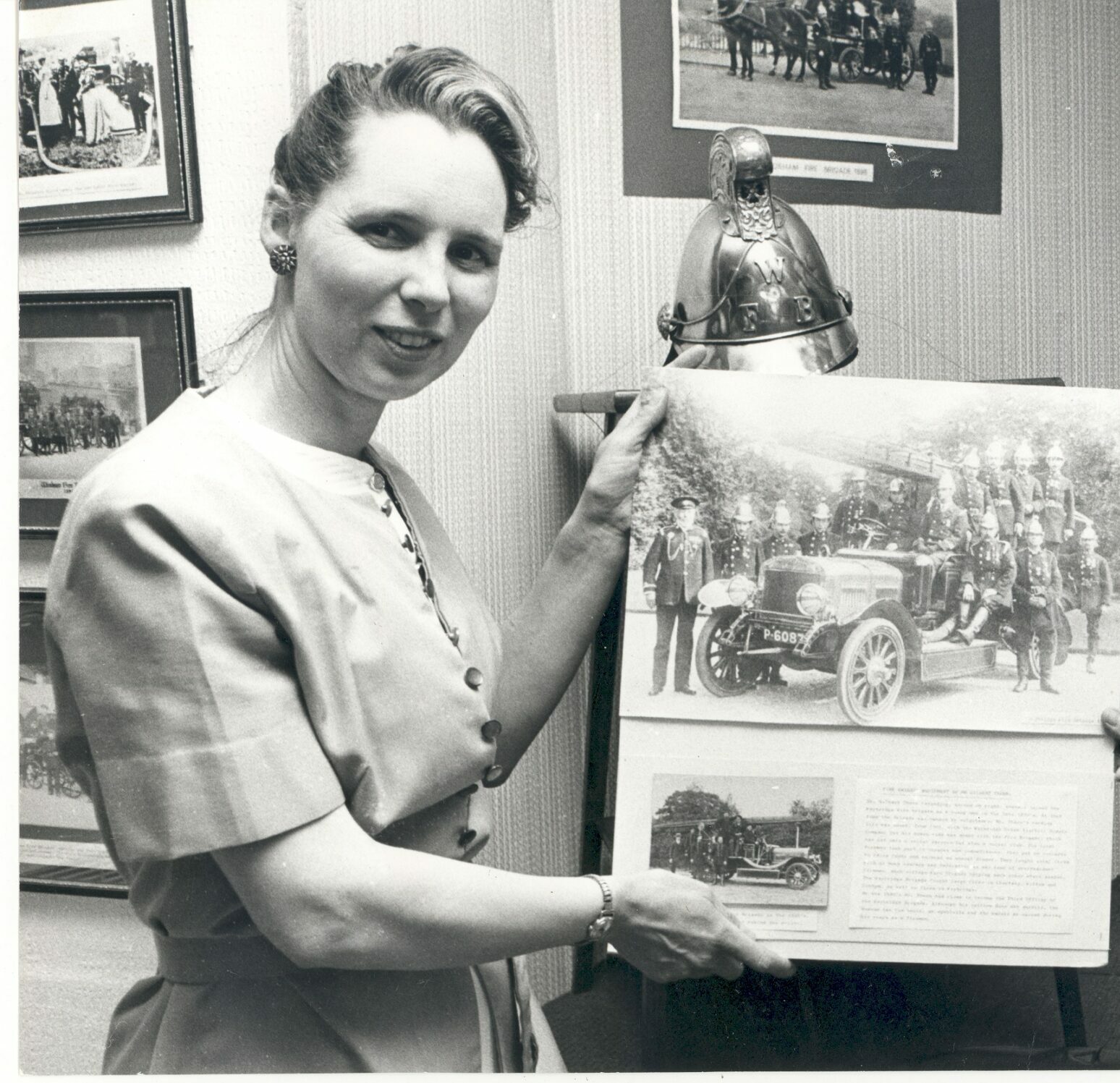 Photograph of Avril Landsdell holding up a photo donated to the museum, 1978.