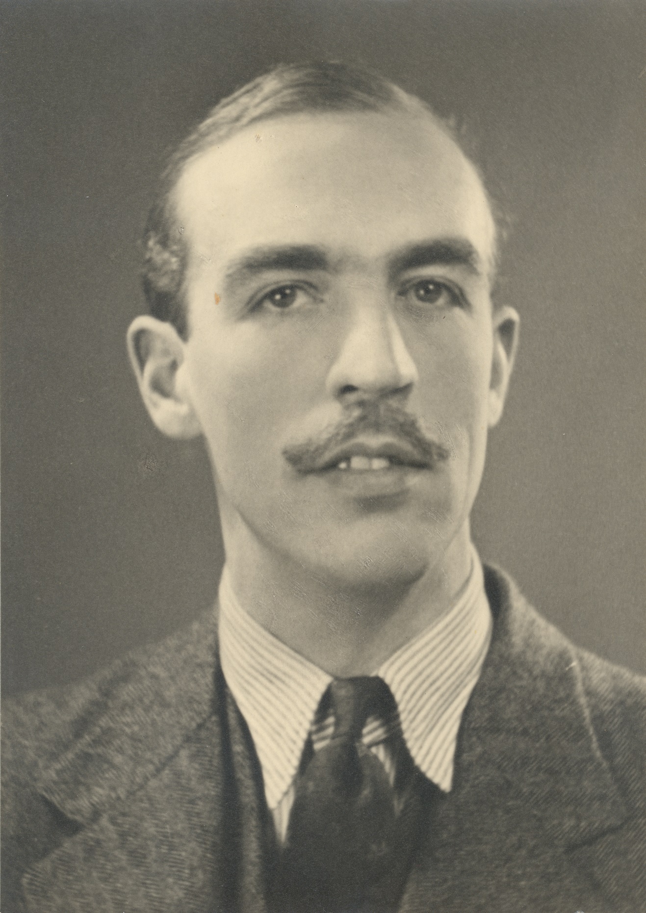 A black and white photograph of Robert John Brooke Gill, taken in the late 1940s when he was in his late-30s.