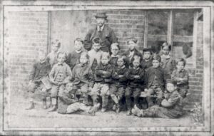 Image of Esher School pupils and master