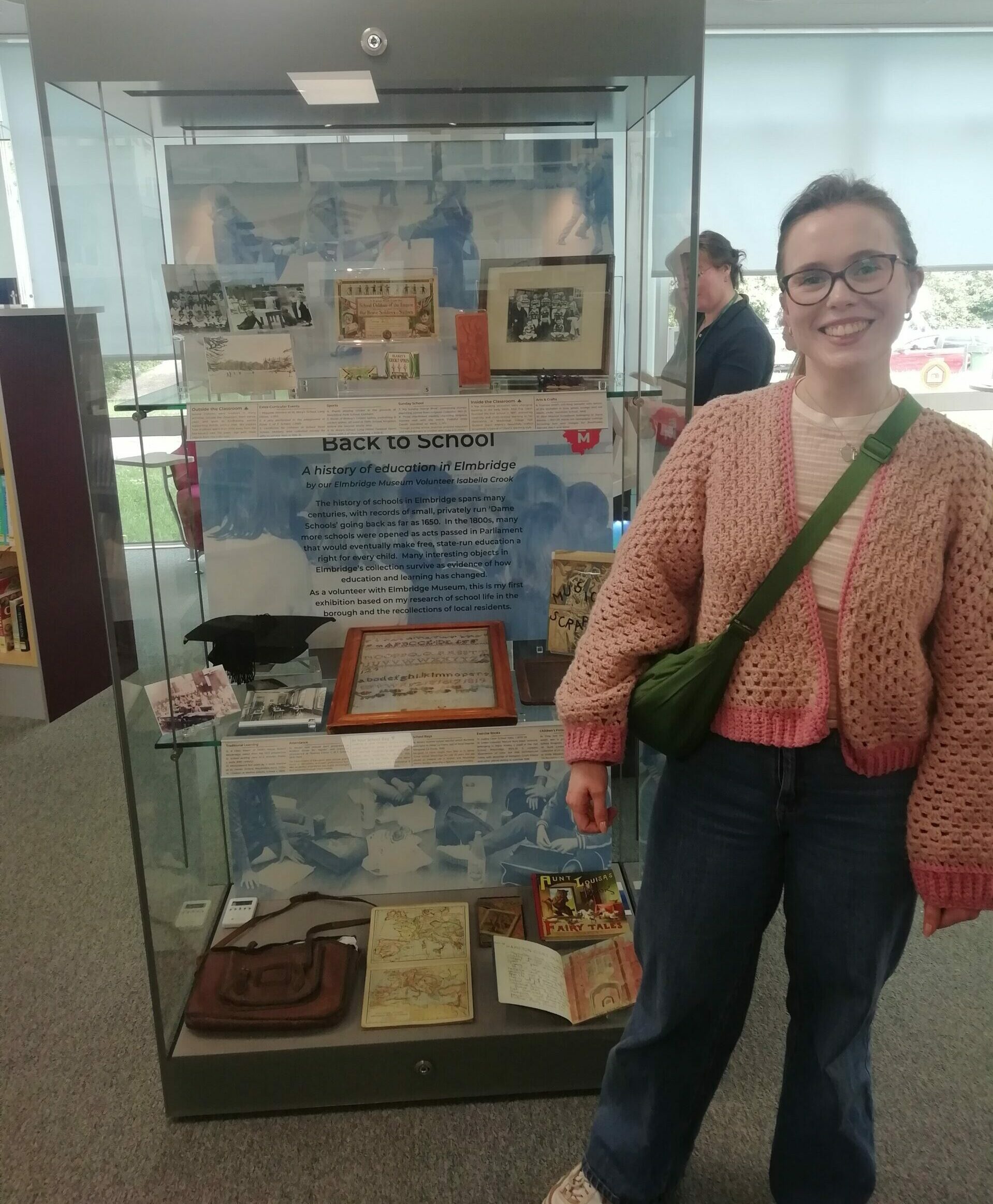 Isabella standing next to her display in Thames Ditton Library.