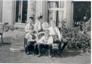 Miss Eva Gilpin with her first 4 students in 1896, at the home of Mr. and Mrs. Sadler in Weybridge. This was just 2 years before she founded The Village Hall School.