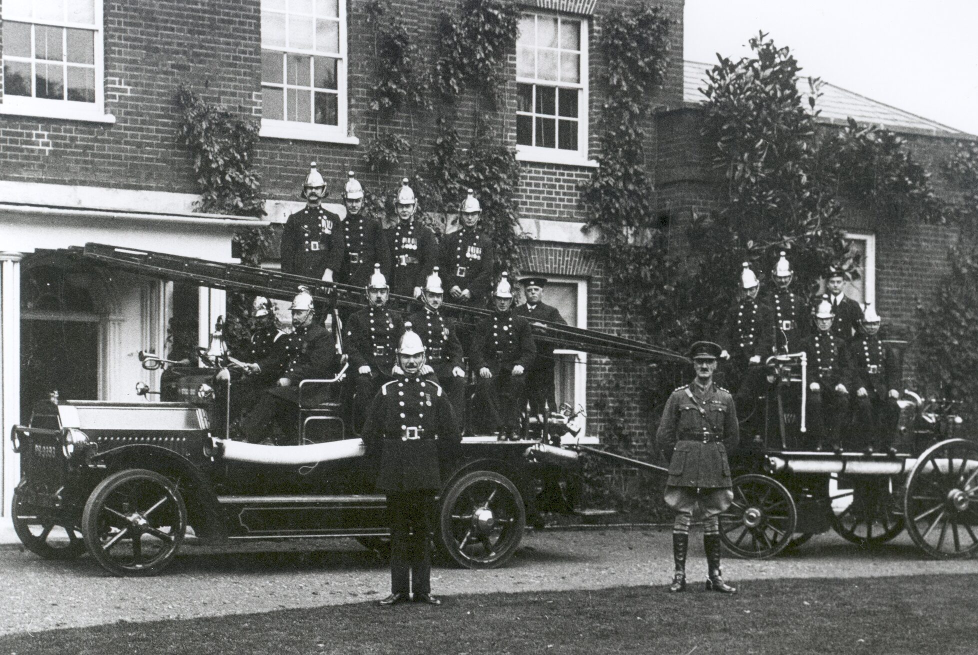 The Walton & Weybridge Fire Brigade in 1921 with their new Dennis motor tender and old Shand Mason steam engine, posed outside Elm Grove under their Chief Officer, Ralph Wilds.