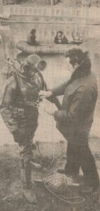 The Police Diving Team, An image of PC George Dobson preparing for a training dive in the Thames at Walton. PC Barry Adams helping him.