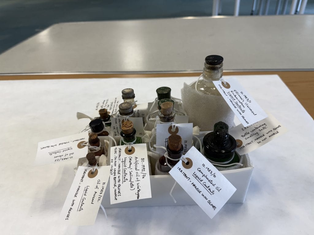 Items containing chemical hazards such as this collection of pharmaceutical bottles have been clearly labelled and stored in a custom-made compartmented tray to avoid spillage.